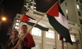 Gaza-dua-orang-pemuda-mengibarkan-bendera-palestina-saat-berunjuk-rasa-jpeg.image