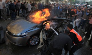 Palestinians extinguish fire from the ca
